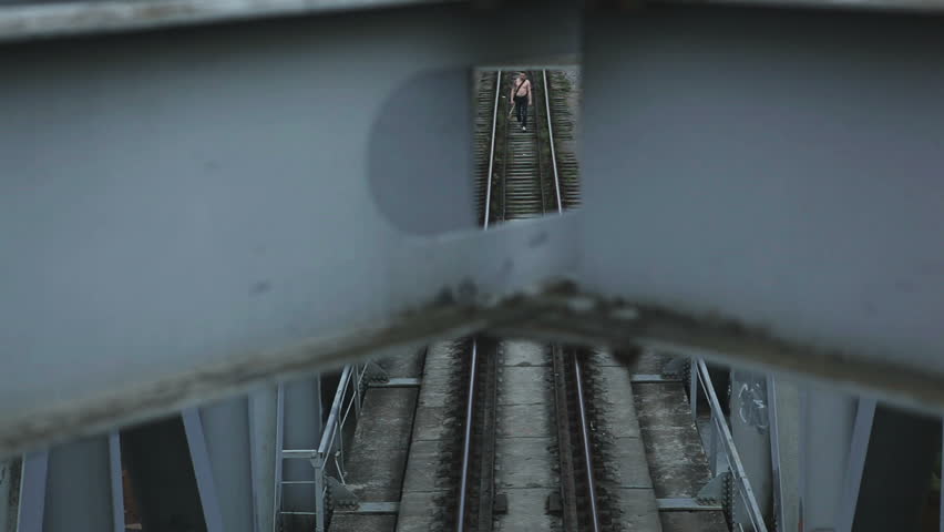 man with guitar goes on bridge