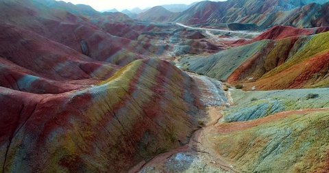 Aerial rainbow mountain landscape in 4k. Drone footage showing the most beautiful valley in Zhangye National Geopark, with sandstone hills covered by colorful pattern. Zhangye Danxia, Gansu, China.