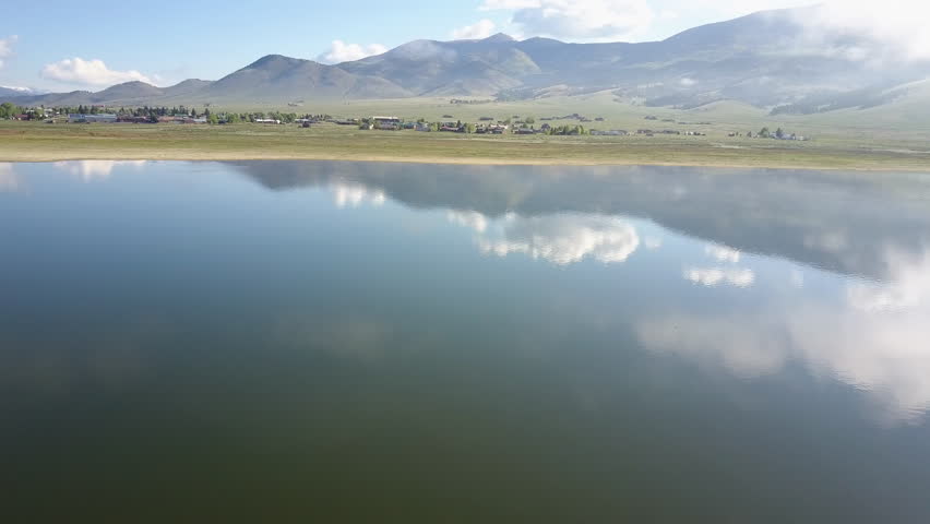 Aerial shot flying over the beautiful Eagle Nest Lake, New Mexico, showing stunning reflections of the surrounding landscape