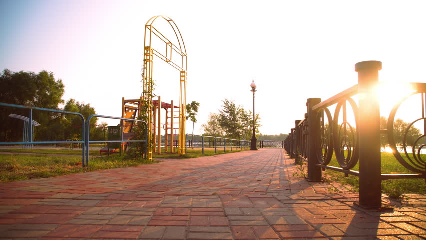 caucasian woman stretching outdoors. runner doing workout before runs. sunrise in summer season beautiful sunlight with sunbeams