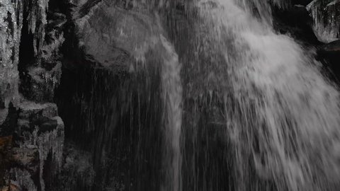 Aerial Drone Flying Close Up Over Waterfall Splashing On Rocks In Canyon In Winter