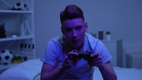 Addicted teen playing computer game late at night, harmful habit mental disorder