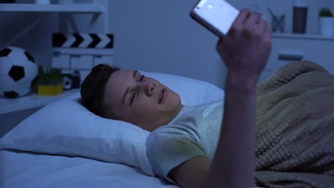 Teenager watching adult content on smartphone and masturbating, puberty age