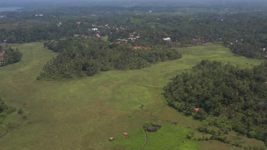 
Flying on a drone above the city and the village on the beach at dawn. Sunny weather. Sri Lanka