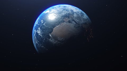 Planet Earth rotates in space from day into night and city lights turn on (Loop).
