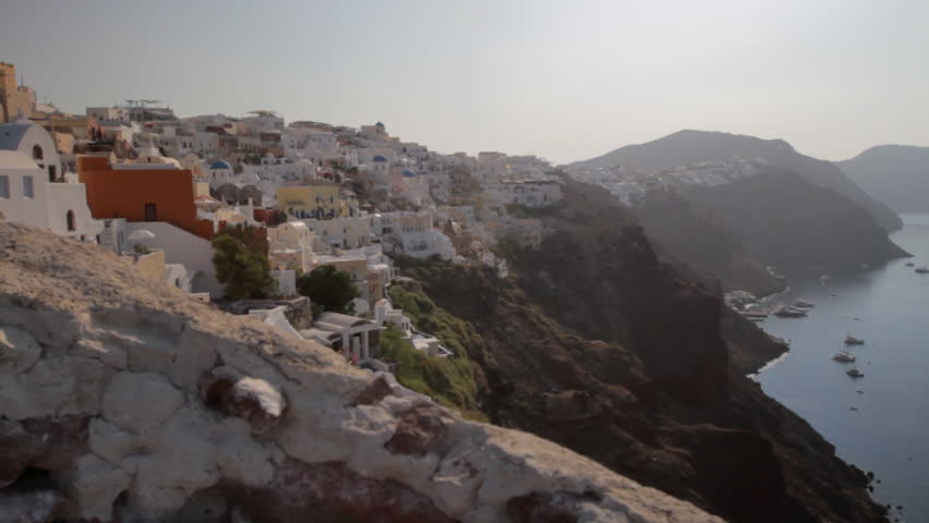 Wide shot of Oia, Santorini. Looks like hanging of the steep cliffs over the majestic Santorini seascape.