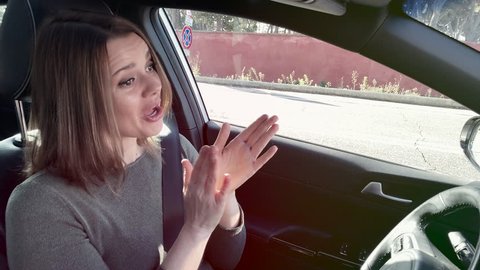 Angry woman driving car screaming unhappy with traffic medium shot