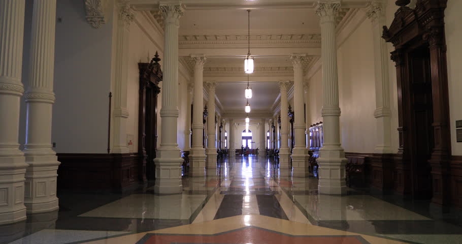 Wife walking towards Texas State Capital building Austin. Texas State Capitol is seat of government. Offices and chambers of the Legislature and Governor. Tourist destination city center.