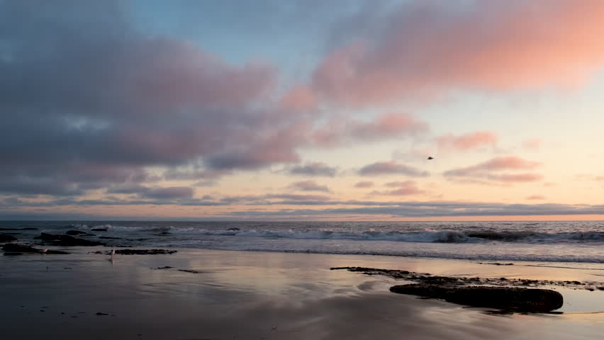 Vibrant Clouds over Relfective Sand Sunset