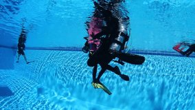 Scuba divers training in a pool