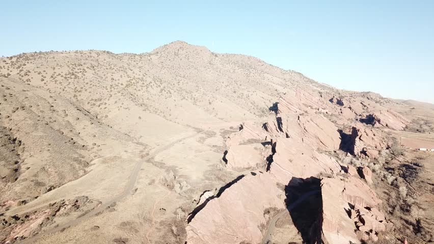 AERIAL: sideways scan over the giant boulders in the Red Rocks Park in Colorado.