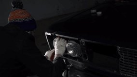 Man repair headlight on the old classic car