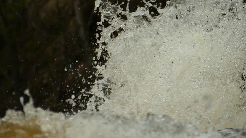 Fascinating movement of water fountain of the stormy 

spring river. Slow motion footage.