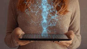 Hologram screen on a tablet with digital dna structure and particles used by businesswoman. - Powered by Shutterstock - Get 15% off with code: PIKWIZARD15