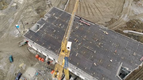 Construction of a high-rise building, a view from the top with a drone. Workers build a house. Panorama from the top of the construction site