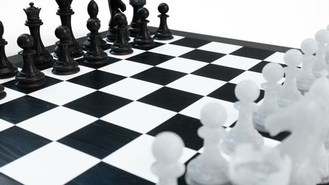 Chess board with pawns, kings, queens, rooks and knights. Chess board isolated on white background. Chessboard rotates. Looped animation, 3d animation