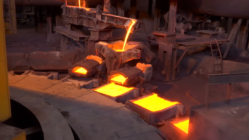 Pouring Molten Copper Into Molds In A Foundry / Processing of copper ore in the foundry,liquid metal is poured into molds Royalty-Free Stock Footage #1025952686