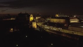 4k. Aerial view of the Old city night Warsaw with the square and the royal palace in the night lighting. Drone shot  Video format RAW.