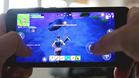 Fortnite gameplay - battle royale app on smartphone in Bologna, Italy, 19 March 2019