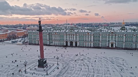 Aerial winter view of Alexander Column, Palace Square, the facade of the Winter Palace and frozen Neva river in historical center of Saint-Petersburg, Russia