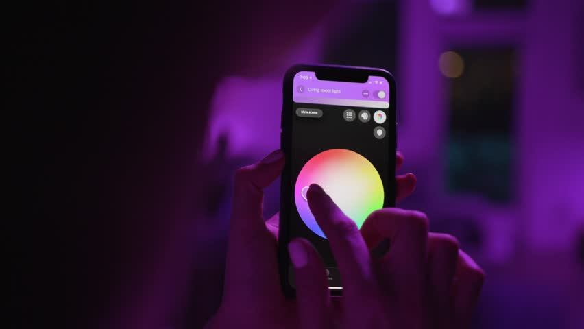 Controlling lights with an app in smart home / Smart house features / Changing mood/color of the lights  | Shutterstock HD Video #1025962796
