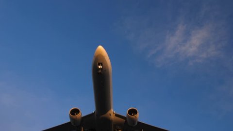 Underside of a big commercial aircraft. Plane flying over head