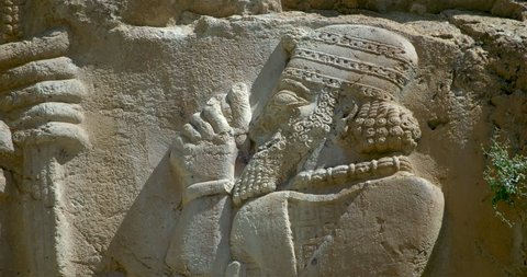 Close up zoom out from King Warpalawas to see  Tarhundas the God of Thunder sculpture on the Ivriz Hittite rock relief sculpture monument, Ivriz, Turkey