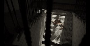 The bride lies on the stairs. Young bride in a magnificent dress is lying on the stairs. Bride in beautiful dress is lying on the stairs. Steep Bride.