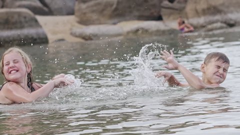 Kids splashing water while swimming
