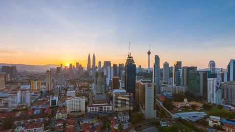 Time lapse: Kuala Lumpur city view during dawn overlooking the city skyline in Federal Territory, Malaysia. Zoom out motion timelapse.
