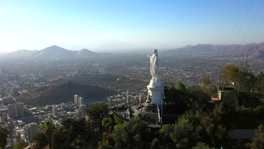 Aerial drone view of Virgin Mary statue at the top of Cerro Cristobal in Santiago, Chile.