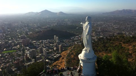 Aerial drone view of Virgin Mary statue at the top of Cerro Cristobal in Santiago, Chile.