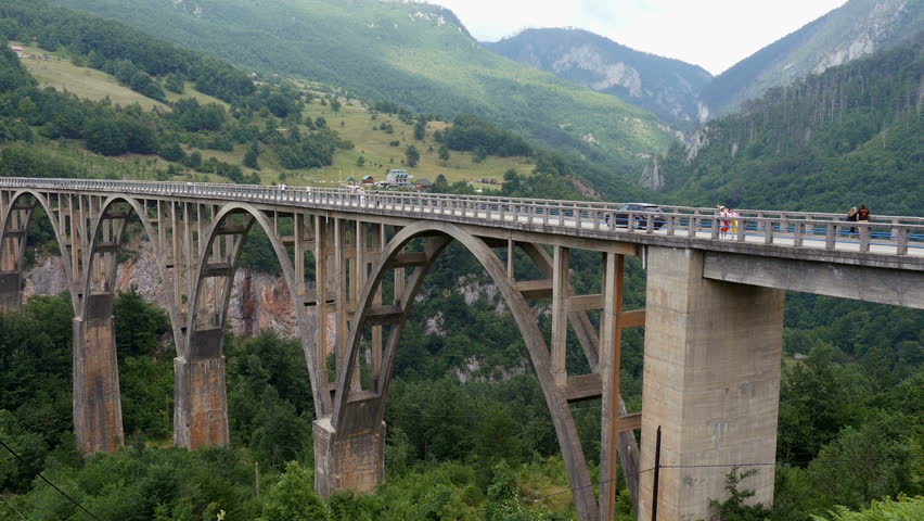 Tara Canyon, Montenegro, July 2017- Tourists walking on the Djurjevic bridge. Tara canyon, Montenegro. Big bridge above canyon