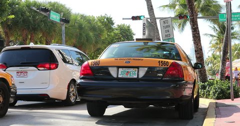 Miami, Florida / USA, February 24, 2019: Yellow Taxi Cab On Ocean Drive (South Beach) In Miami Beach, Art Deco Historic District, Florida, United States - DCi 4K Resolution