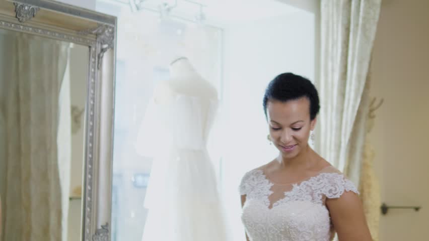 Beautifu bride choosing wedding dress in a wedding salon