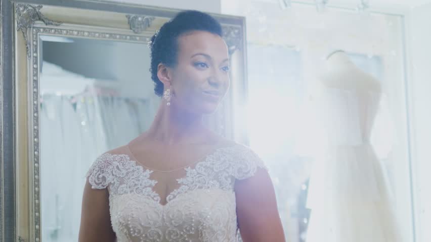 Beautifu bride choosing wedding dress in a wedding salon