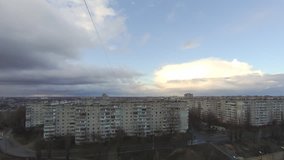 Time lapse transition from day to night with rain clouds over the city