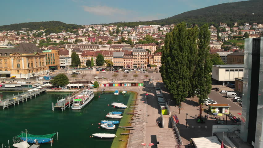Drone dollyshot sideways view of the city of Neuchatel, Switzerland and its lakeshore