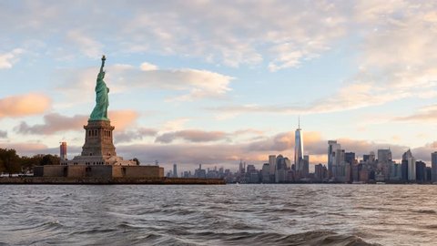Cinemagraph view of the Statue of Liberty and Downtown Manhattan in the background during a vibrant cloudy sunrise. Taken in Jersey City, New Jersey, United States. Still Image Continuous Animation