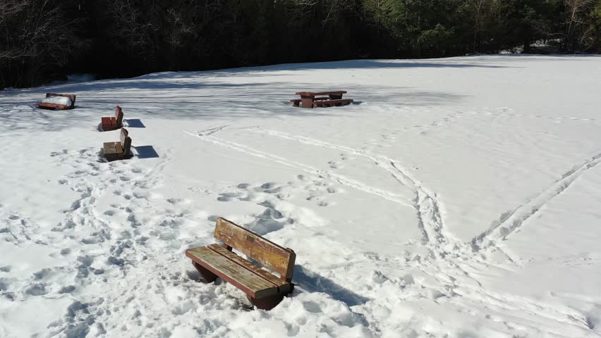 Low Aerial View at Snow Trail in Park. Drone Flying 4K.