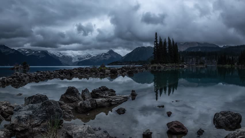 Cinemagraph of Beautiful landscape view of a Glacier Lake during a dark cloudy sunset. Taken in Garibaldi Provincial Park, located near Whistler and Squamish, North of Vancouver, BC, Canada. 