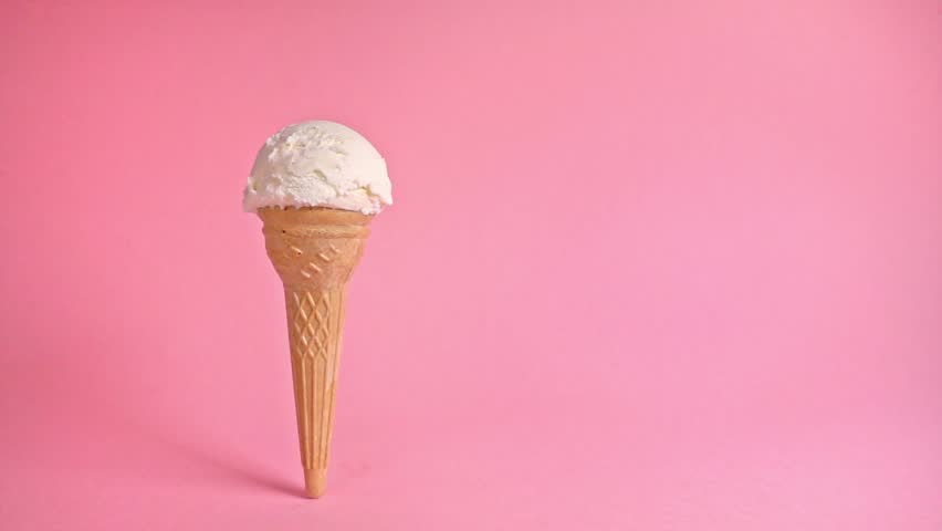 funny creative concept of wafer cone with ice cream covered and strewing sprinkles on pink background, copy space, slow motion, cinemagraph Royalty-Free Stock Footage #1026003932