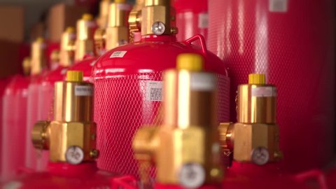 Red gas cylinders with pressure valves.