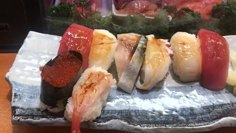 Various of Sushi and Sashimi.Japanese national dishes seafood are most of the ingredients come from the sea,Assort Japanese rice, shrimps, fish, scallops, salmon, tuna, squid, ginger on plate.
