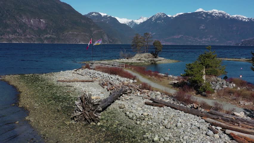 Aerial view over Burrard Inlet, ocean and island with mountains in beautiful British Columbia. Canada. 4K.