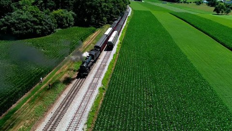 Starsburg, Pennsylvania / United States - 07 08 2018: Strasburg, Pennsylvania, July 2018 - Steam Train at Picnic Area, Dropping off Passengers as Second Steam Train Passes, in Amish Countryside