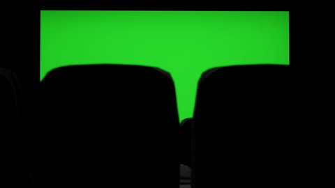 Cinema interior of movie theatre with blank movie theater screen with green screen and empty seats. Movie entertainment concept.