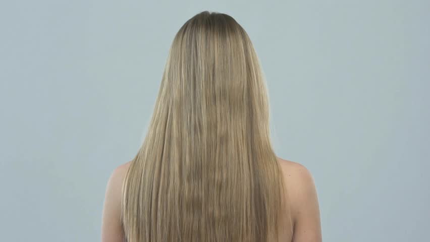 Beautiful blond woman with long hair. Woman with straight hair, posing at studio. Slow motion. Rear view | Shutterstock HD Video #1026018128