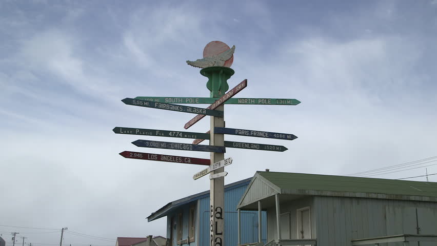 Board sign indicating different destination around the world, Barrow, Alaska