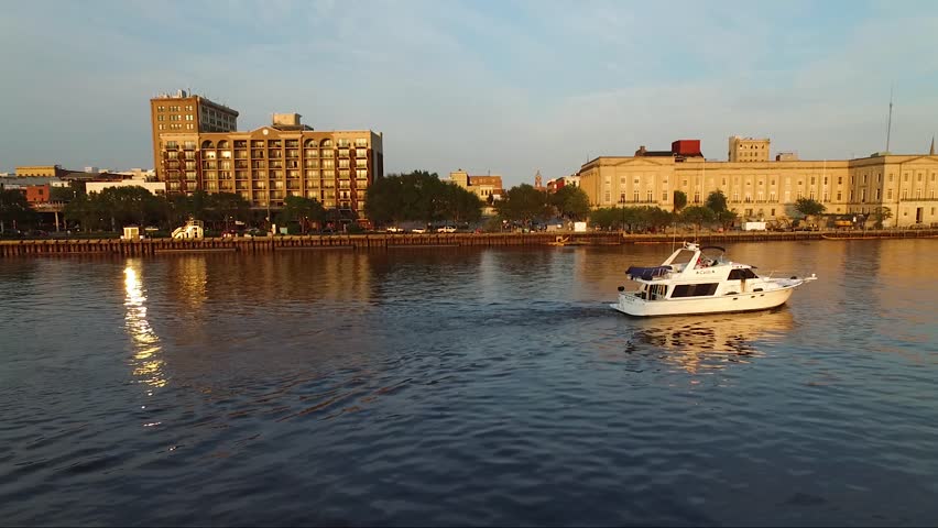 Tracking a boat on the Cape Fear River close to downtown Wilmington NC and the battleship at sunset